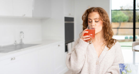 female enjoying a glass of hormonal supplement drink